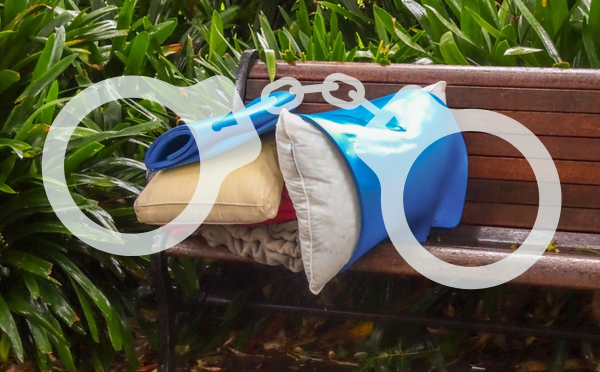 Pillows and blankets on a park bench